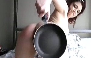 Thick young girl spanks ass with a frying pan