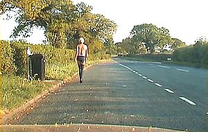 Mature shemale walking on a road