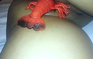 Passed out used girl giving birth to a lobster toy  