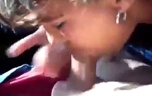 Brunette slut sucks cock in a car