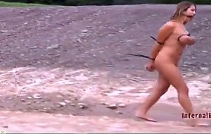 Naked slave girl in the mud