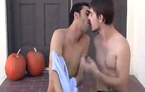 Two strong boys kiss each other