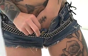 Artfully inked girl kleio valentien posing in a leather bra and tight shorts