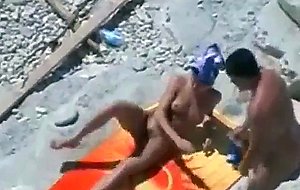 Two couples fool around on the beach
